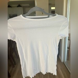 White t-shirt with ruffle tips.